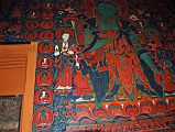 Lo Manthang Thubchen 06-1 Main Assembly Hall Painting Of Amoghasiddhi To Right Of Door Above and to the right of the main entrance door is an excellent large painting of what I think is green Amoghasiddhi, the Dhyani Buddha of the north, in the mudra of fearlessness. British architect John Sanday on Thubchen gompa: 